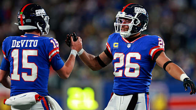 Tommy DeVito celebrates a touchdown with Saquon Barkley.